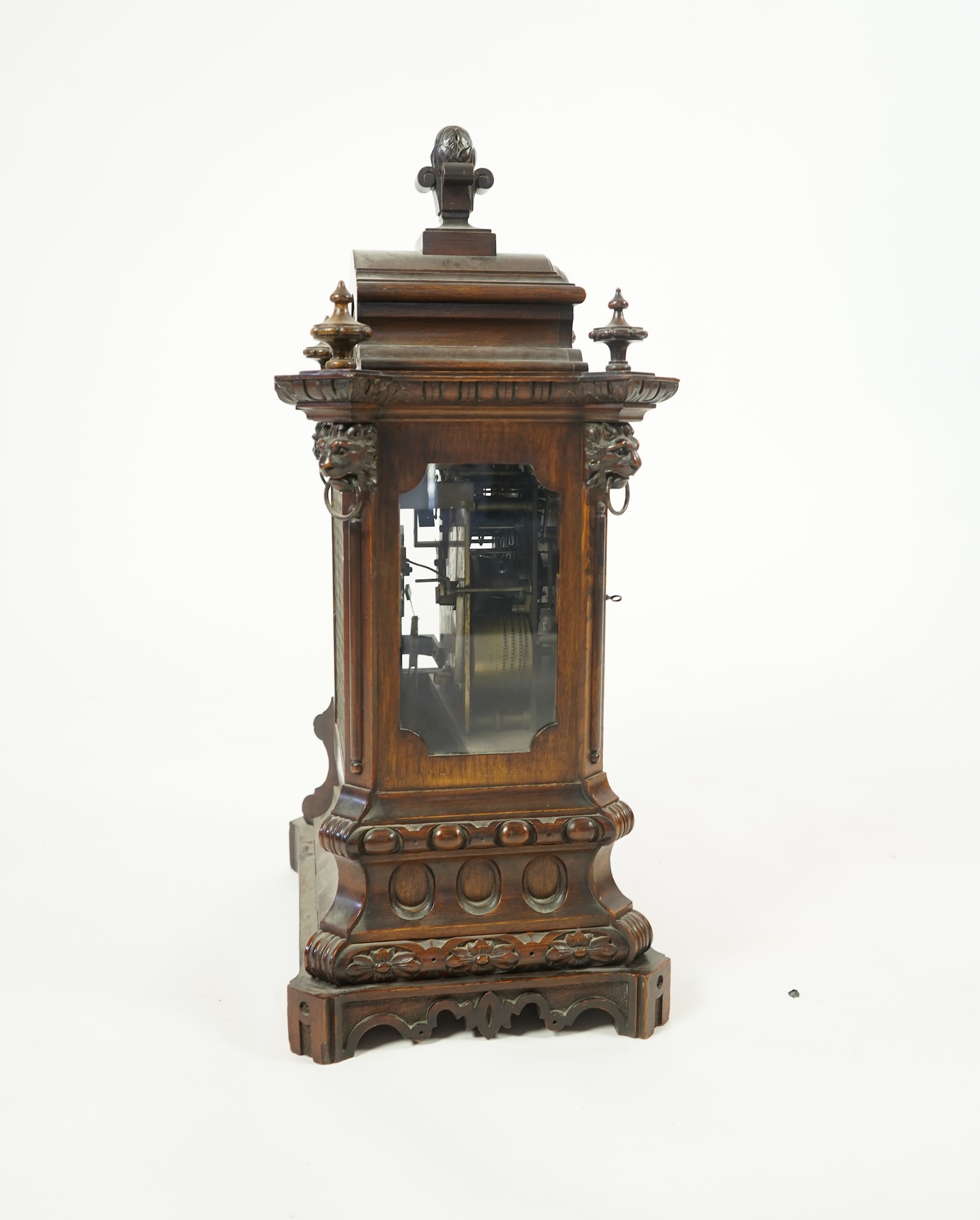 A late 19th century carved oak triple fusee bracket clock